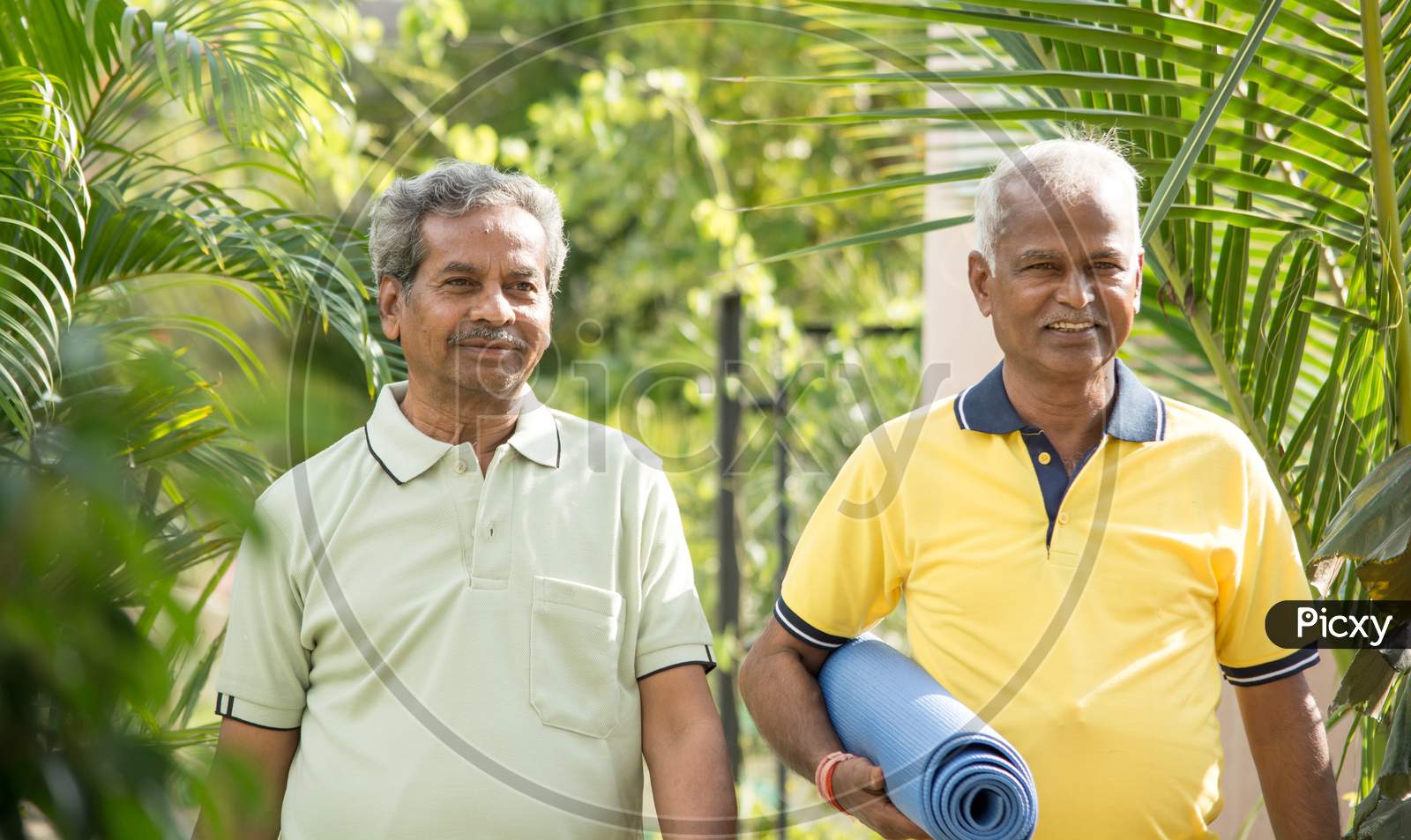 A couple of Old or Elderly Men's Walking Together with Yoga Matt in Hands
