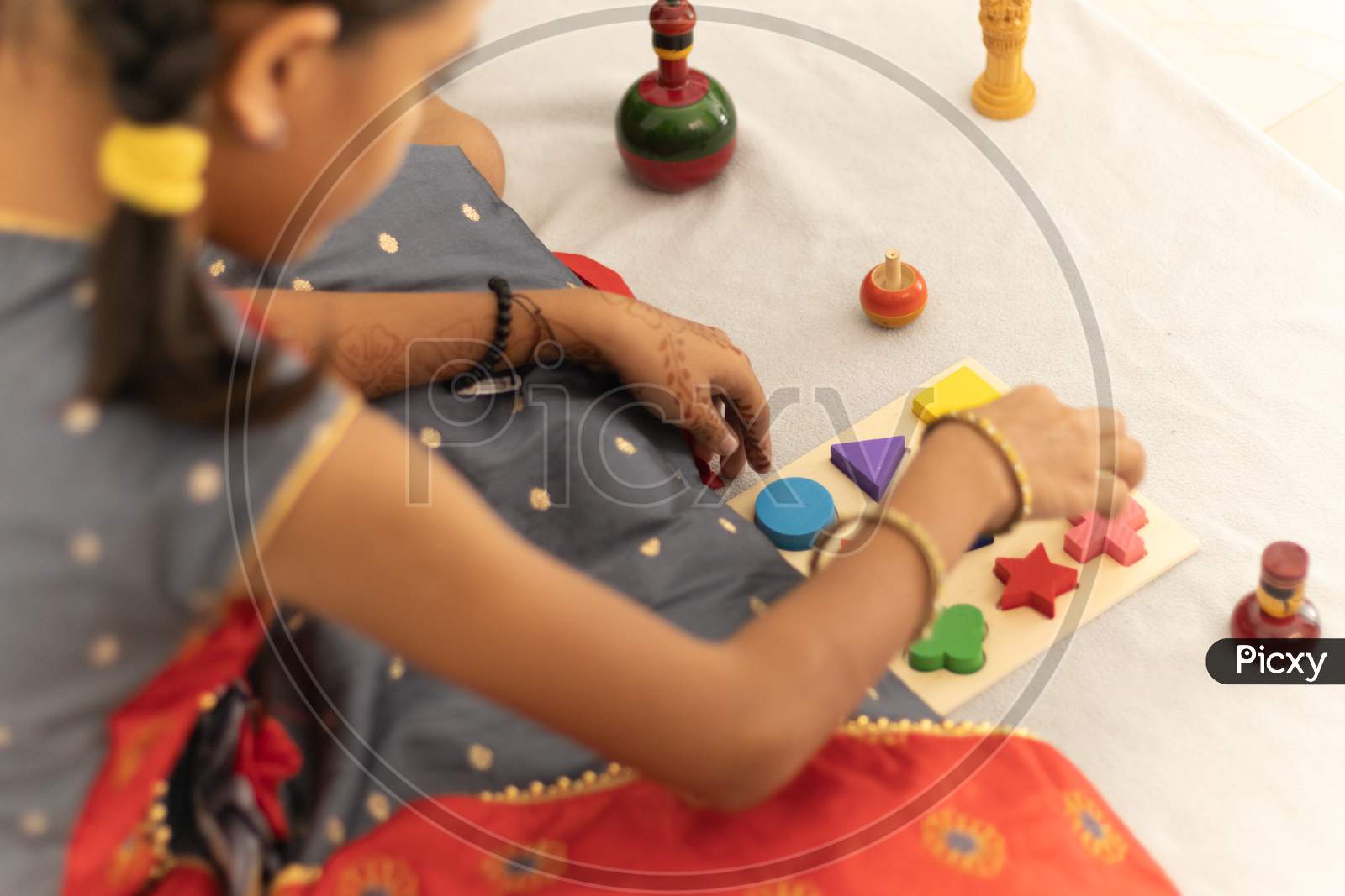 Cute Little Child Girl Playing With Indian Wooden Channapatna Toys In The Room