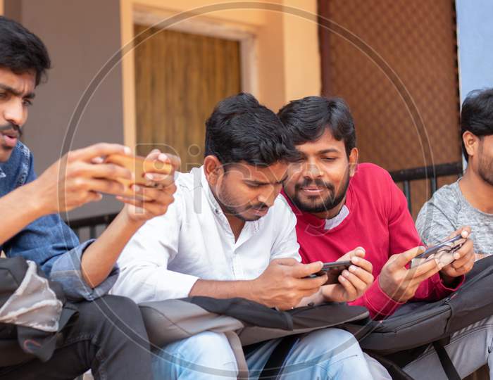 Group of Students using mobile phones or Smartphones At College - Education, Learning Student, People Concept