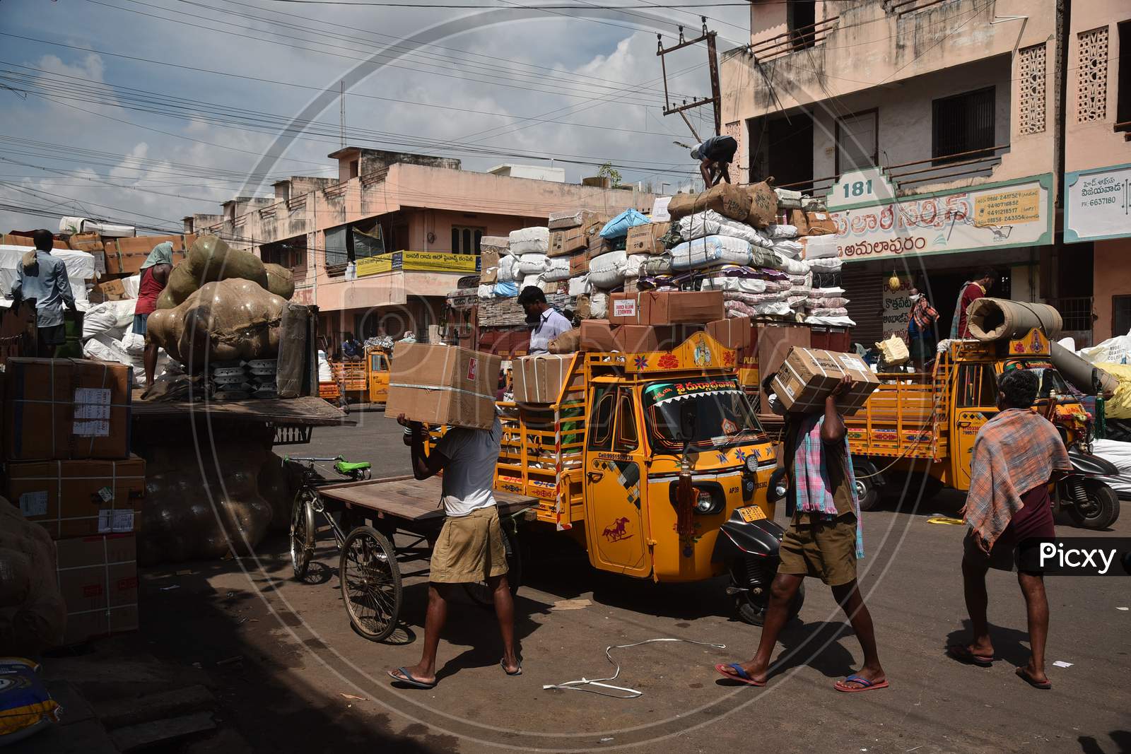 Laborers work at Mahatma Gandhi wholesale commercial market after authorities eased restrictions, during the fifth phase of coronavirus lockdown in Vijayawada.