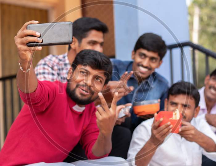 A Group of Young Men's taking a Selfie while having Lunch together At a University Campus or College Campus