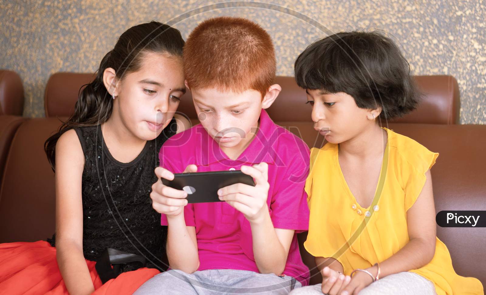 Group of Kids using Mobile Phone or Smartphone