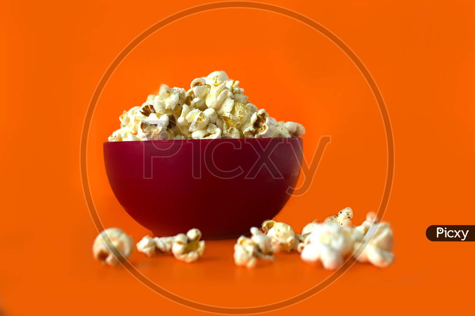 Pop Corns in a Bowl with orange Background