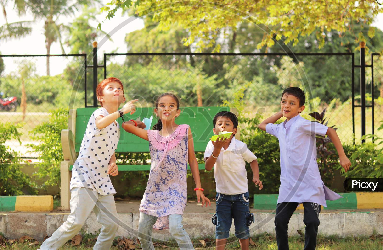 Children's Playing Paper Rocket Game At Park, Outdoor - Boys And Girls, Plays A Paper Rocket Game - Kids Playing Traditional Games Outside During Leisure.