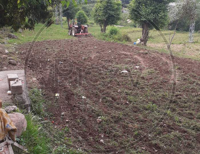 Agriculture cultivation tractor on the soil