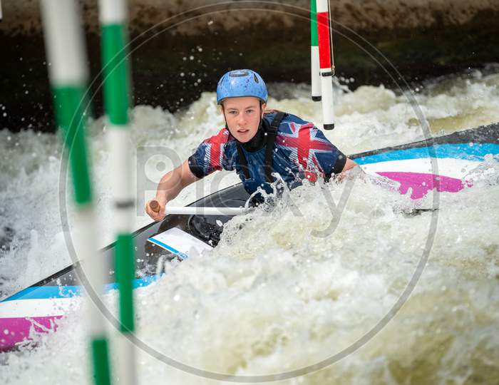 Close Up Action Of A Gb Canoe Slalom Athlete Negotiating The Poles Of Slalom Gates On White Water In The C1W Class