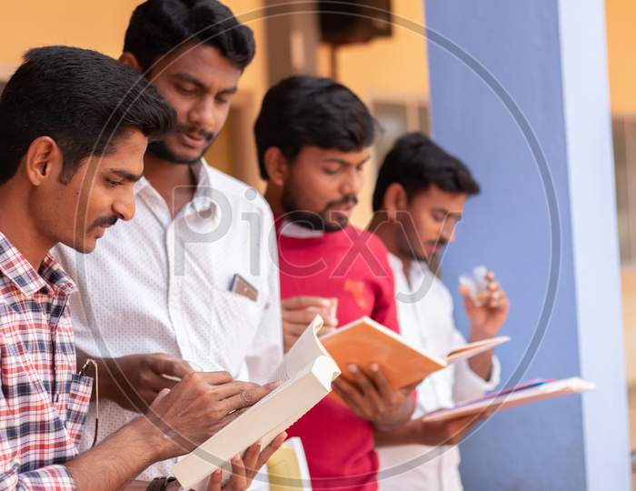 Group Of Students studying together and clearing doubts by Looking Into Books At College - Education, Learning Student, People Concept