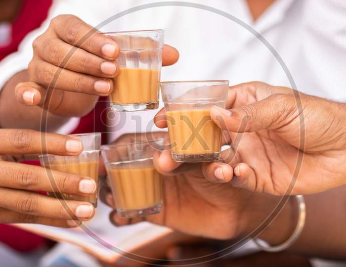 Close up shot of People holding Chai Cup