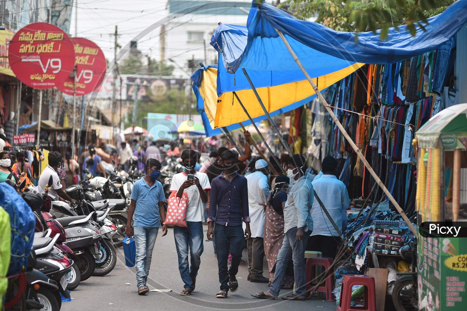People shop at Besant road, during the fifth phase of coronavirus lockdown in Vijayawada.
