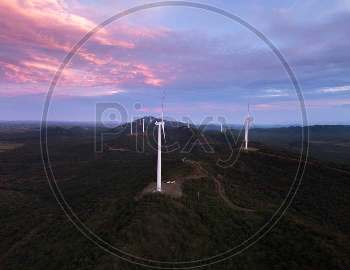 Aerial shot of windmills during sunset - wide shot