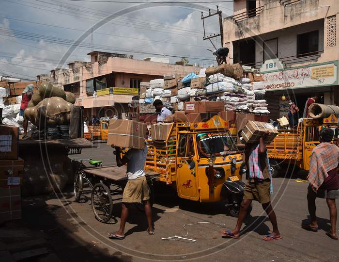 Laborers work at Mahatma Gandhi wholesale commercial market after authorities eased restrictions, during the fifth phase of coronavirus lockdown in Vijayawada.