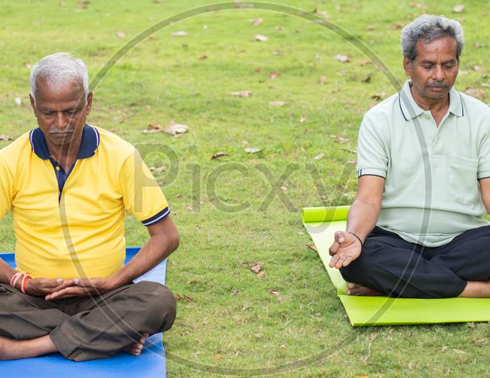A couple of Elderly Man Or Old Men's Doing Yoga, Fitness Routine At Outdoor