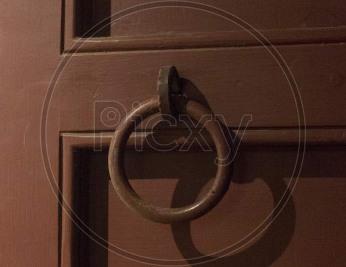 An Iron Handle on a Wooden Door