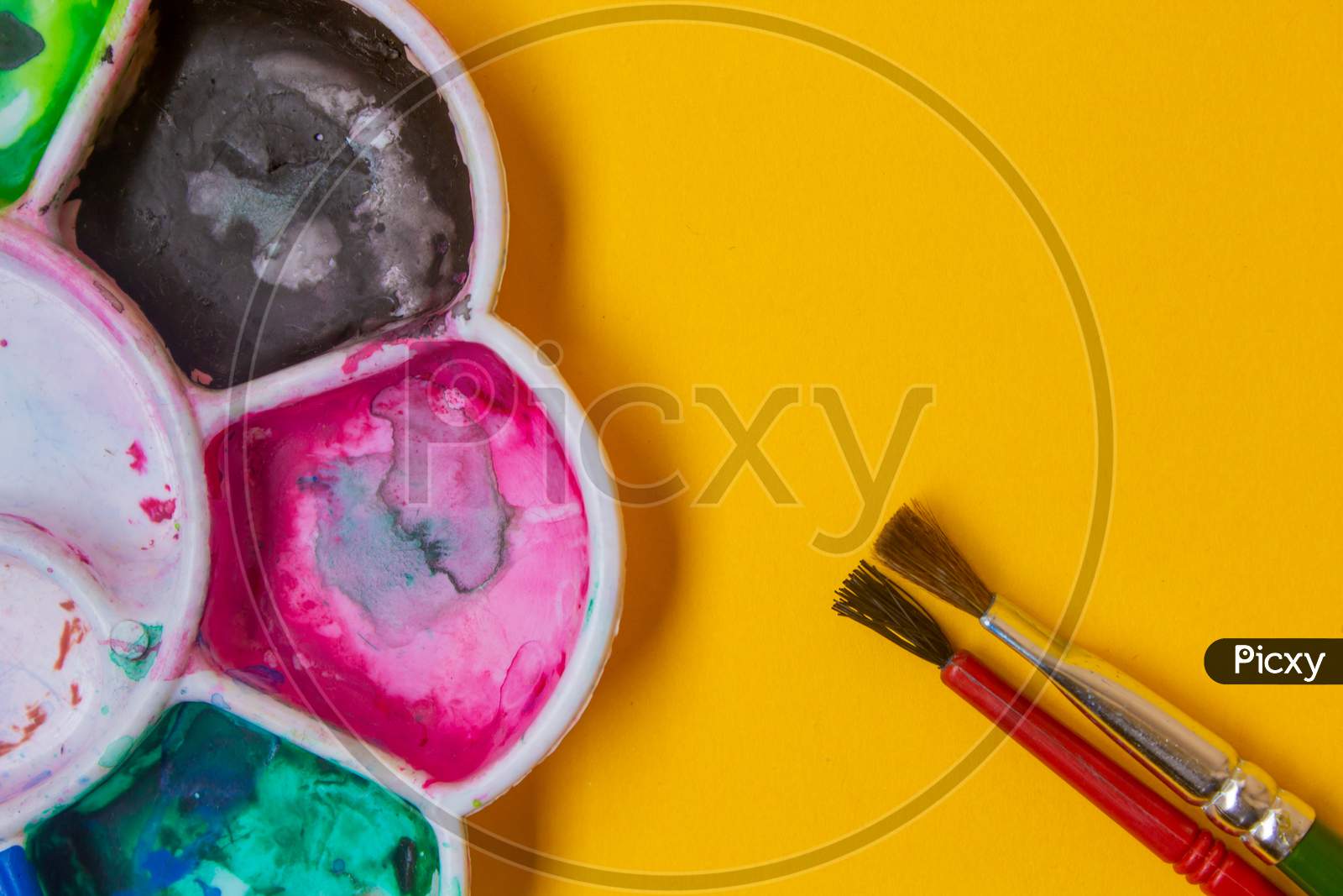 View Of Paint Palette With Different Colors And Paint Brushes. Selective Focus.