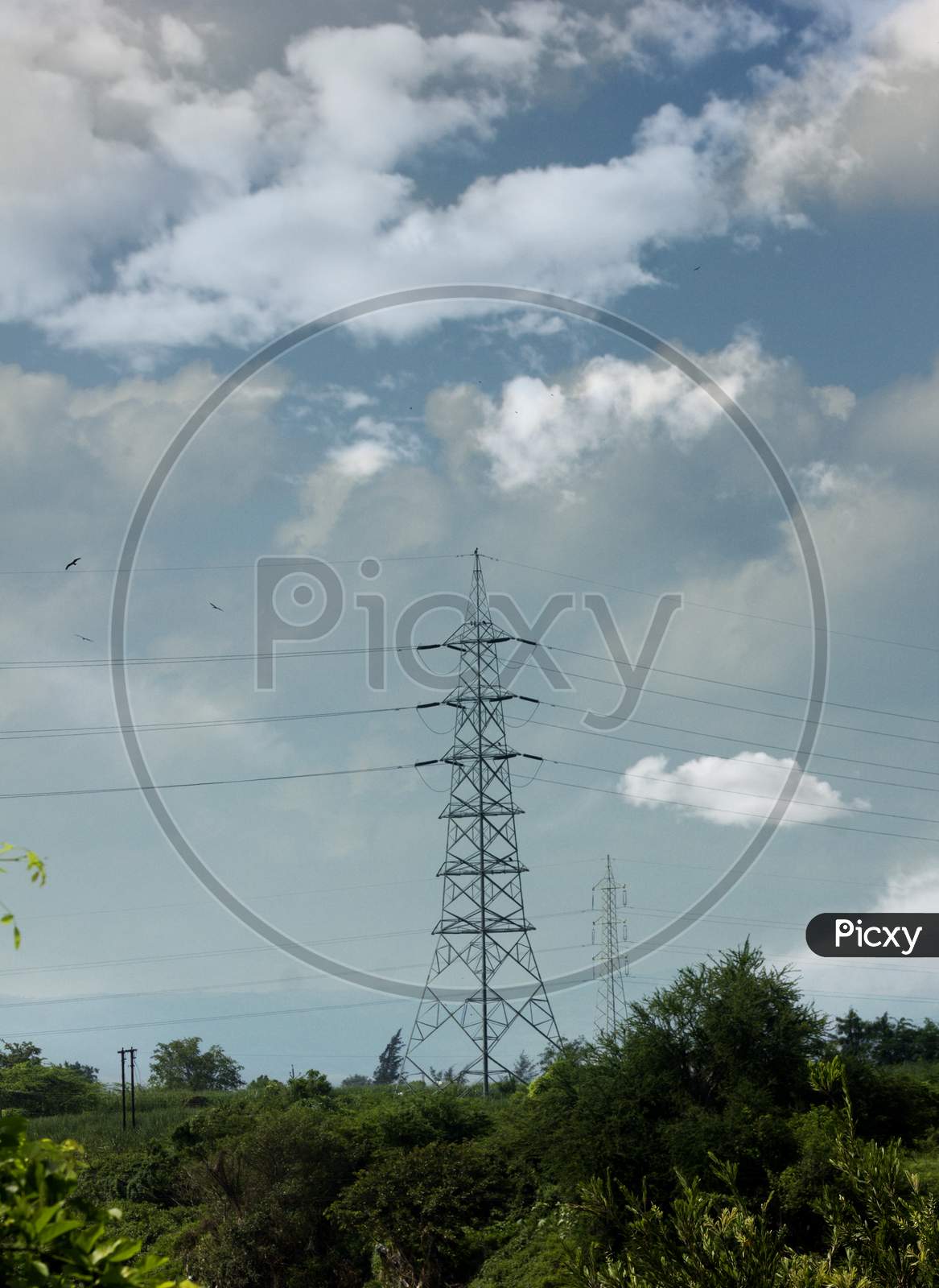 An Electric Tower with Clouds in the Background
