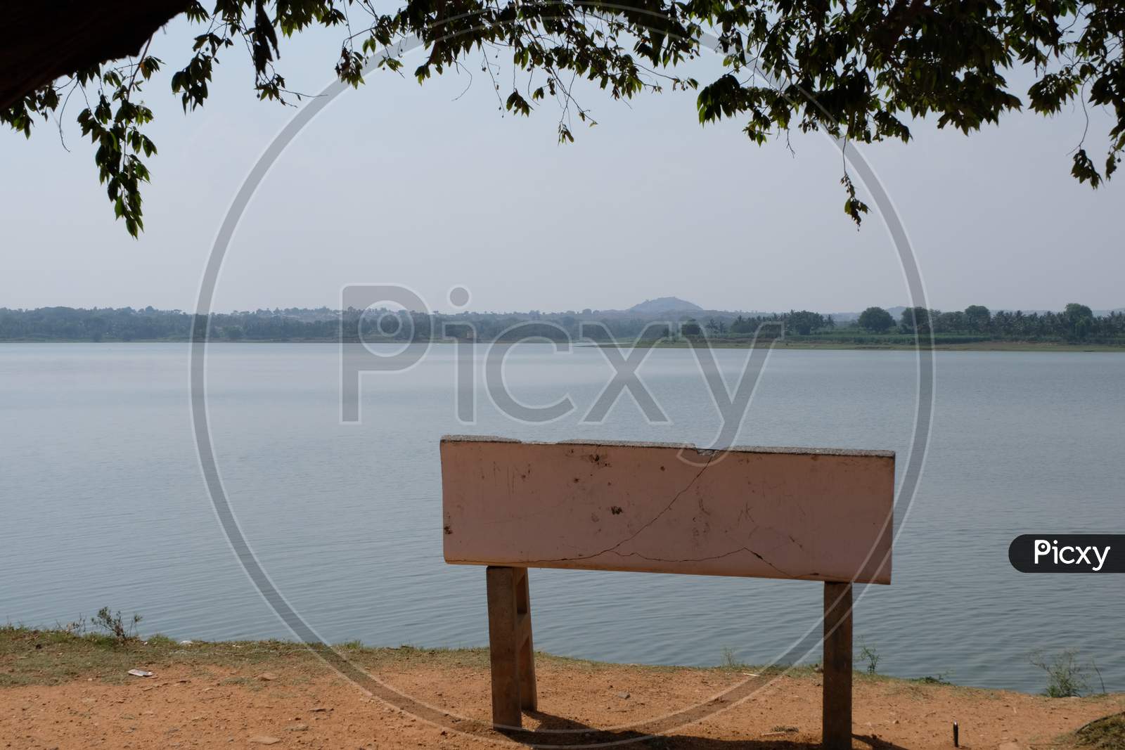 Lone stone bench overlooking a lake
