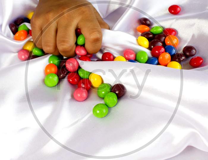 Gems Chocolates on white coloured cloth