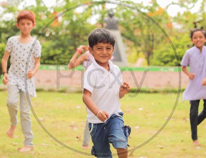Children Playing Outdoor Traditional Games - Concept Of Kids Enjoying Outdoor Games In Technology-Driven World.