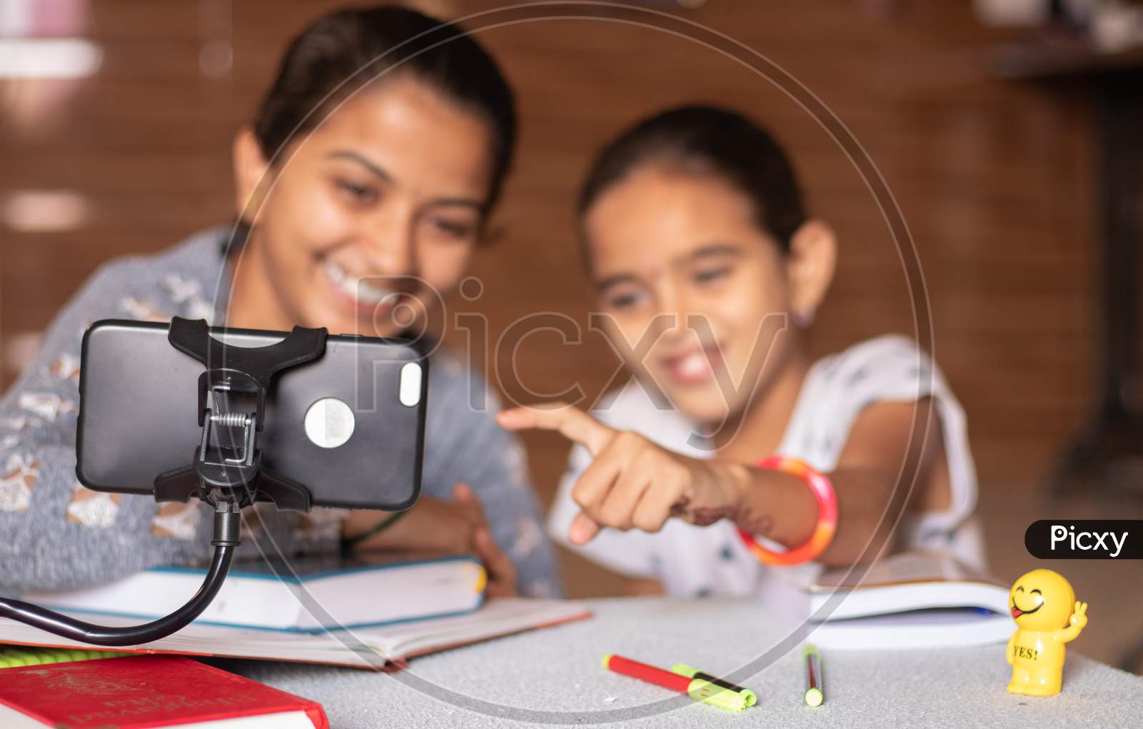 Young Girl Teaching Her Sister At Home - Concept Of Online Homeschooling During Coronavirus Or Covid-19 Lockdown Pandemic