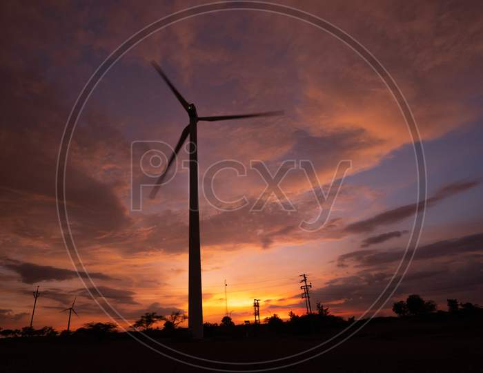 Silhouette Of  Windmills During Sunset