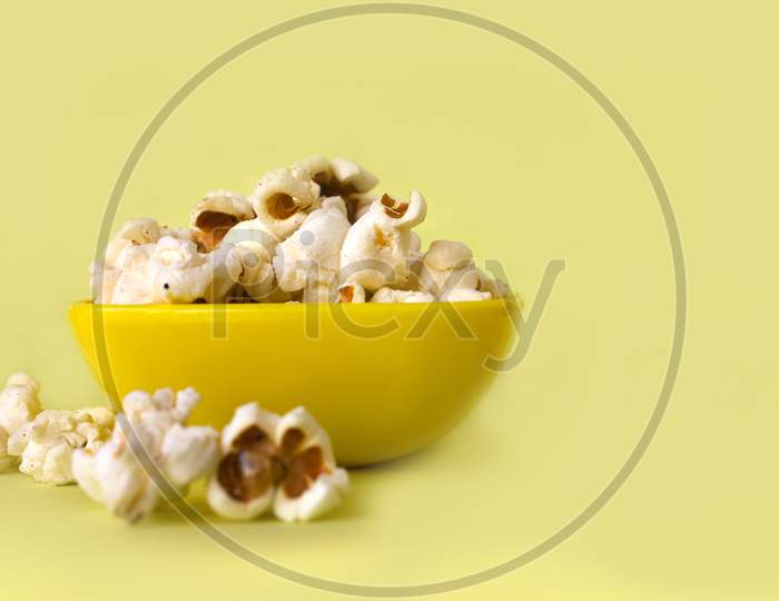 Pop Corns in a Bowl with yellow Background