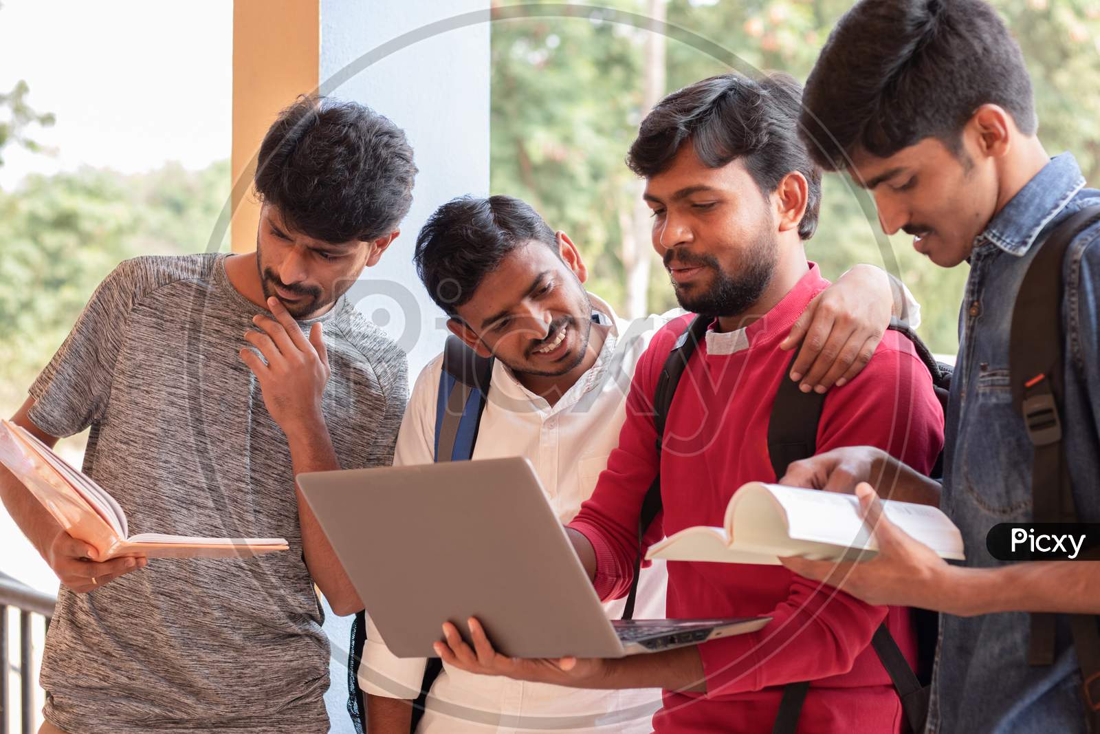 Group of Students looking at a Laptop In College - Education, Learning Student, People Concept