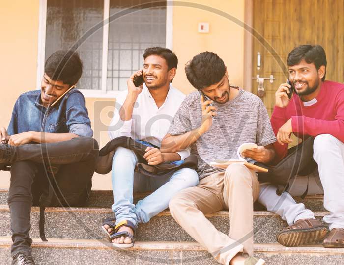 Group of Students using  mobile phones or Smartphones At College - Education, Learning Student, People Concept