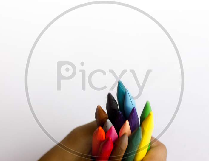 Close up shot of a Person holding Colour Pencil's