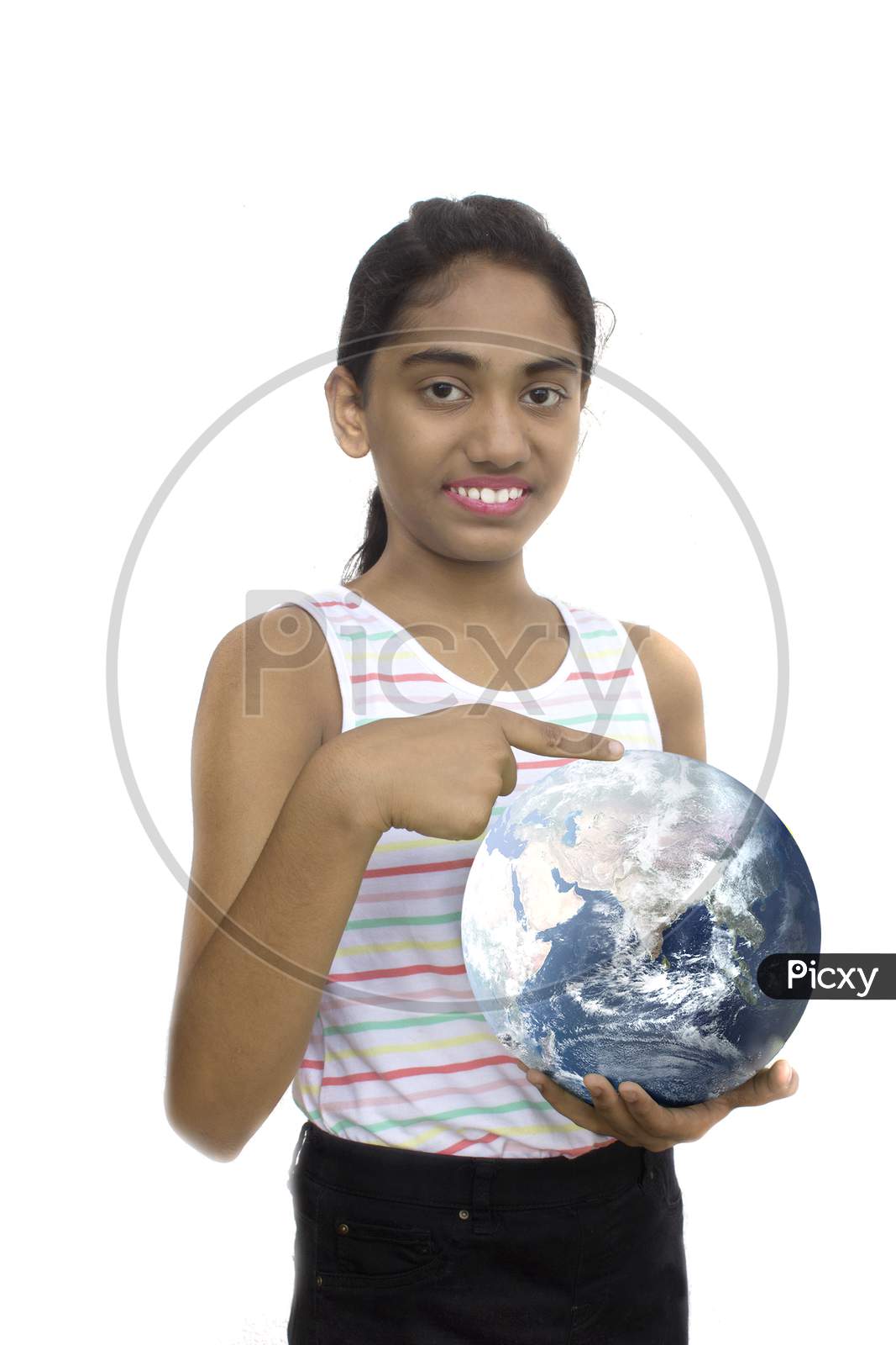 Portrait of a Young Indian School Girl pointing towards A Globe