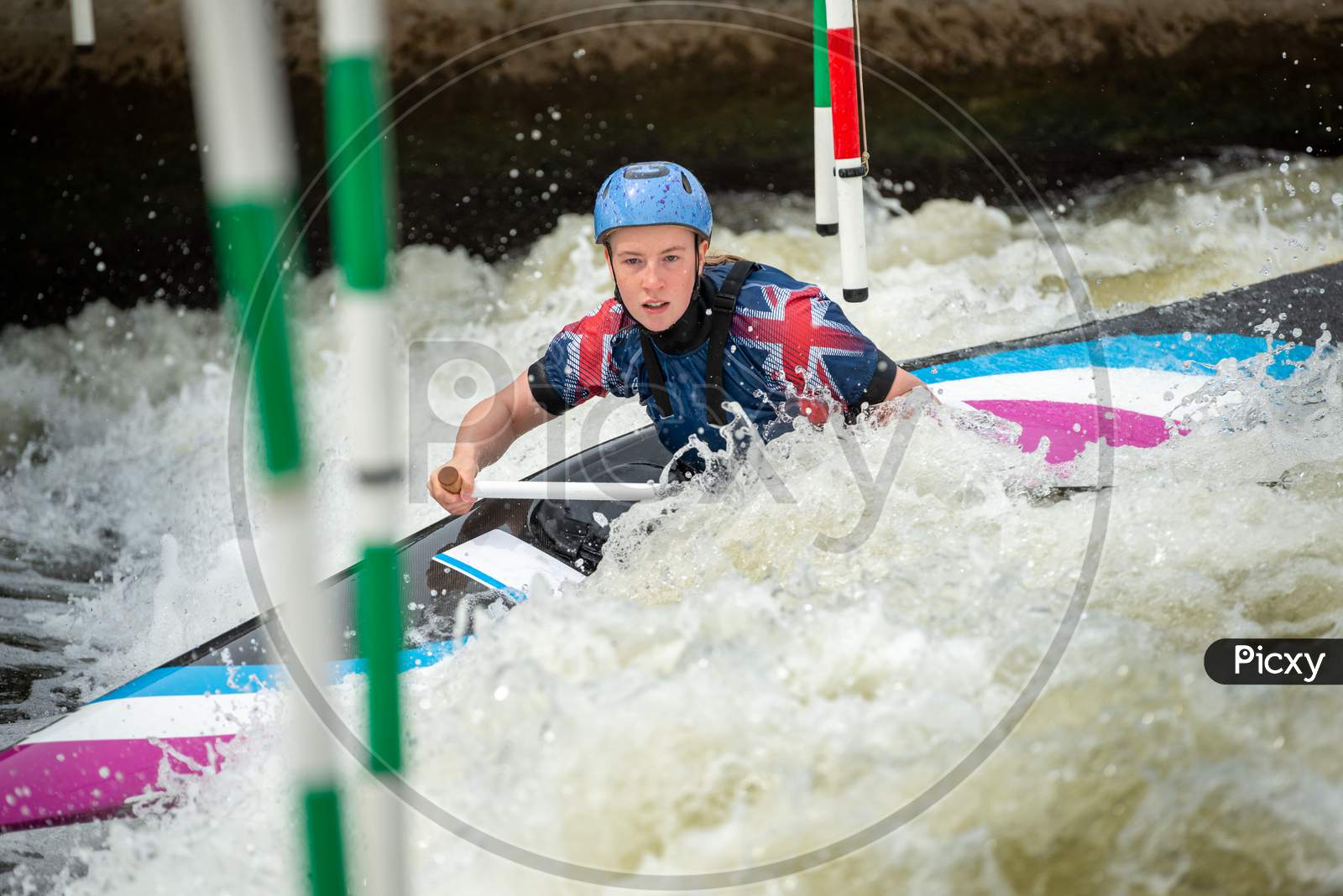 Close Up Action Of A Gb Canoe Slalom Athlete Negotiating The Poles Of Slalom Gates On White Water In The C1W Class