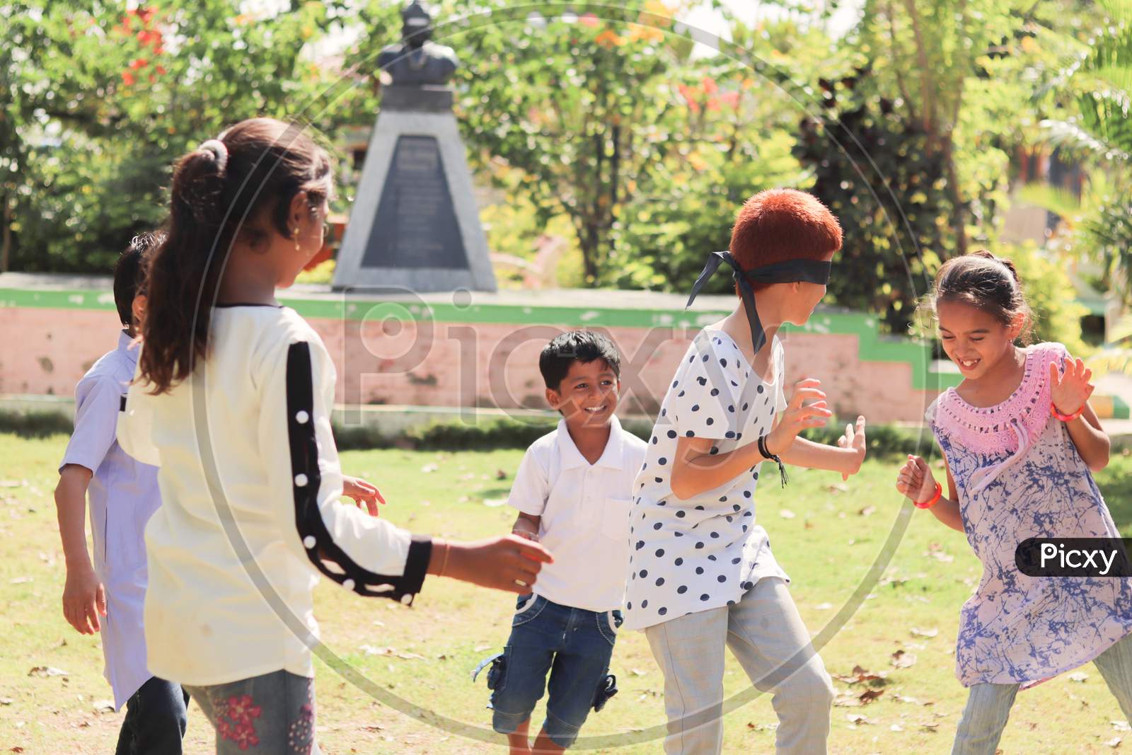 Children's Playing Hide and Seek A Traditional Game At a Park, Outdoors - Concept Of Kids Enjoying Outdoor Games In Technology-Driven World.