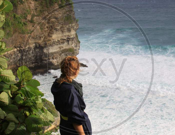 Woman At Uluwatu Bali Looking At Waves And Ocean