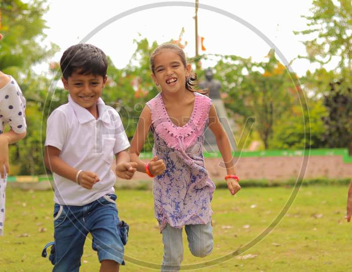 Children Playing Outdoor Traditional Games - Concept Of Kids Enjoying Outdoor Games In Technology-Driven World.