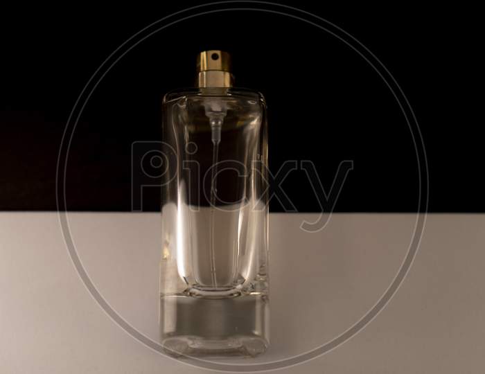 Perfume bottle isolated against white and black background.