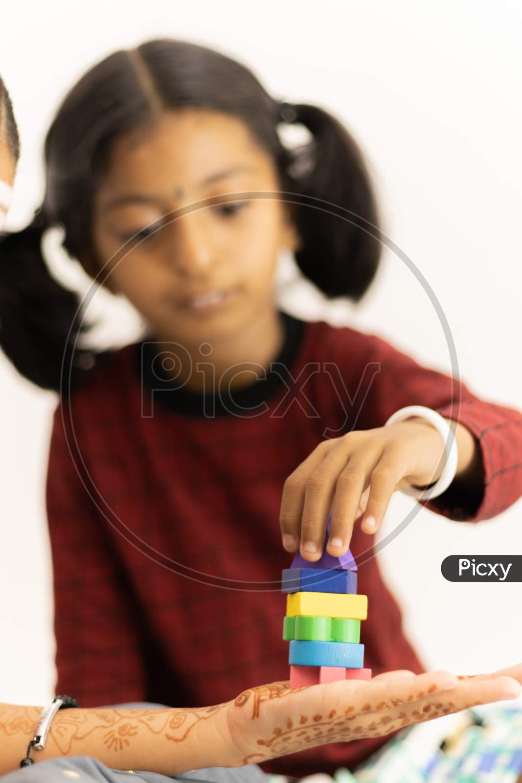 Focus On Hands Of Cute Little Child Girl Playing With Colorful Wooden Blocks At The Home.