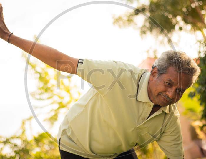 Senior Man or Old Man doing Yoga, Fitness routine At Outdoor