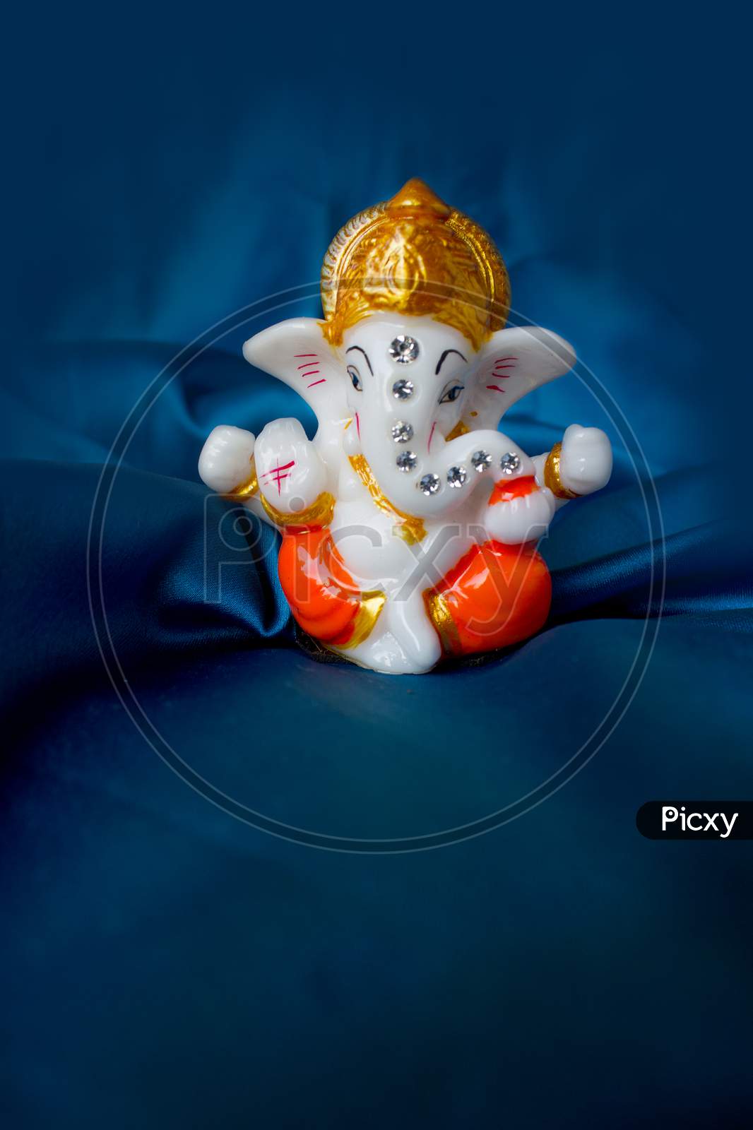 Image of Lord Ganesha Idol with Blue Background-RL994724-Picxy