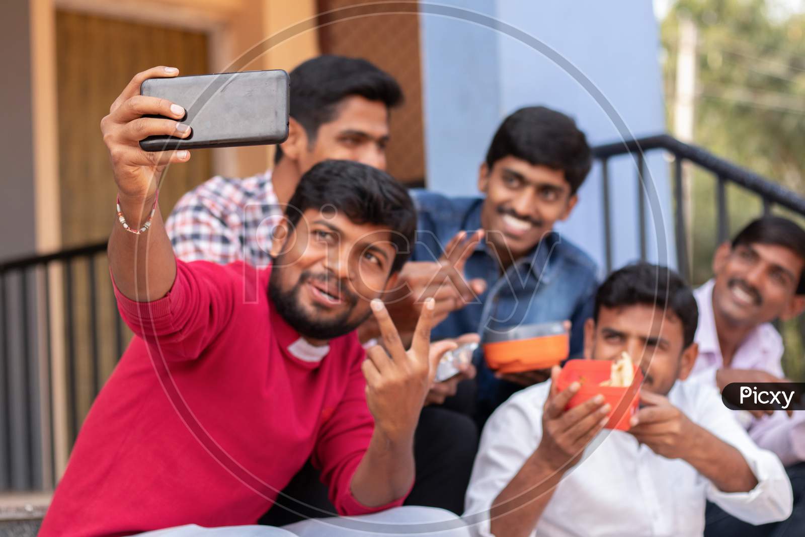 A Group of Young Men's taking a Selfie while having Lunch together At a University Campus or College Campus