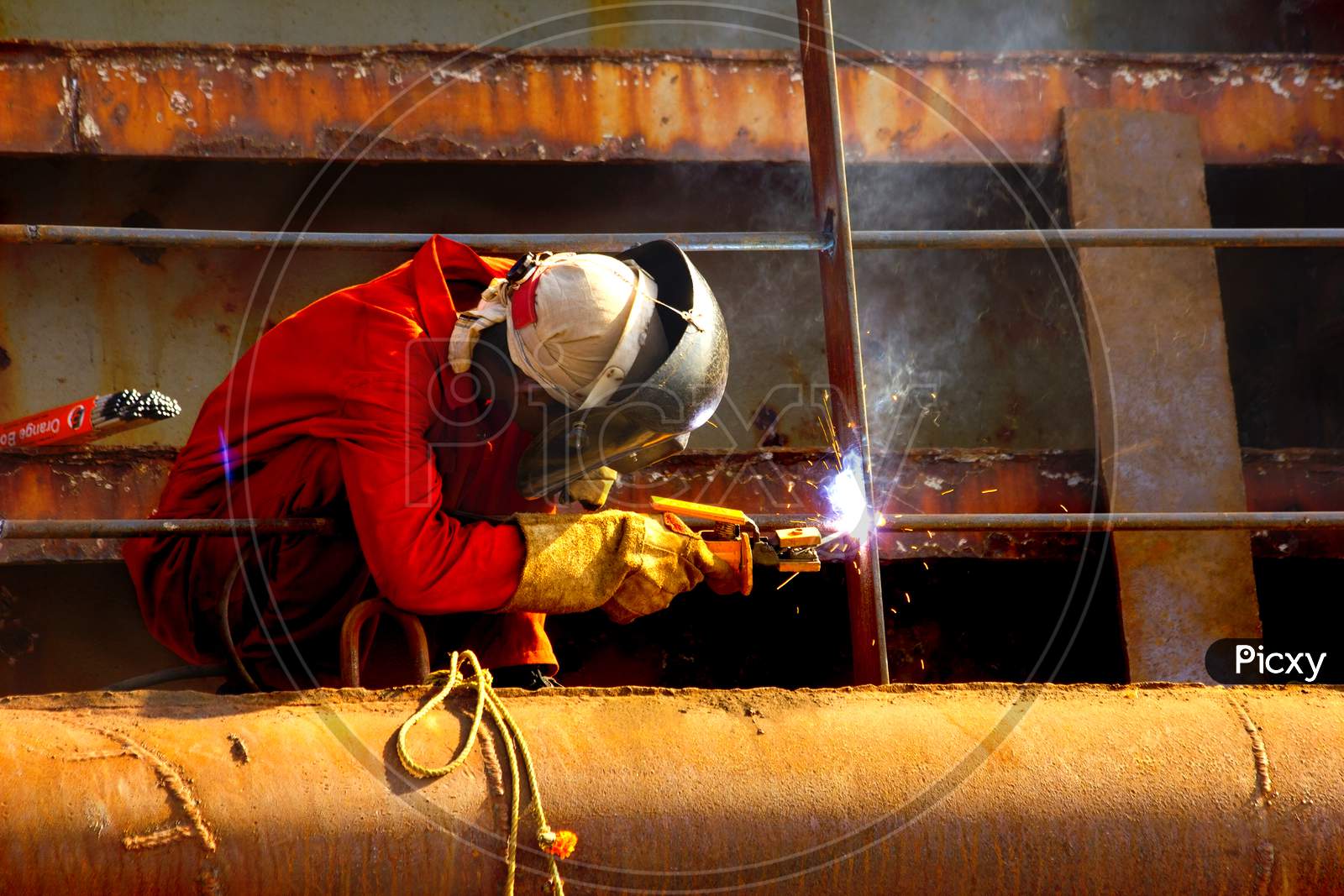 A Worker doing welding with a Helmet on