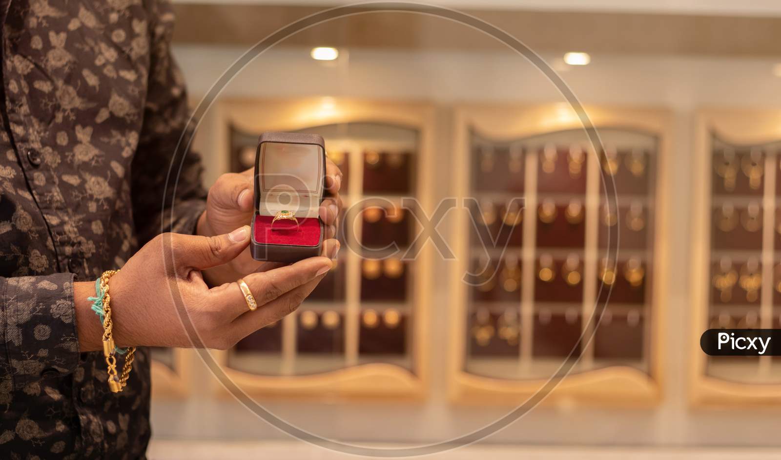 Close Up, Hands Showing Gold Ring with Jewelry Box With Copy Space At Jewellery Store