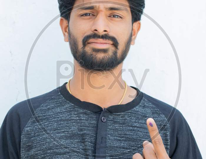 Young Indian Voter Show His Ink-Marked Finger After Casting Vote In Indian Election On Isolated Background.