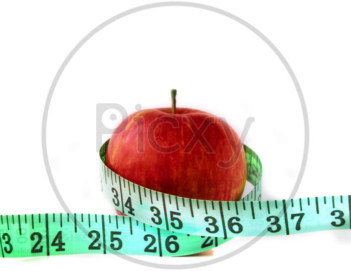 An Apple with measuring Tape on White background