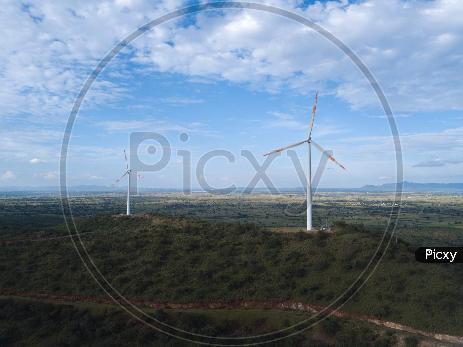 Aerial shot of windmills on a bright sunny day