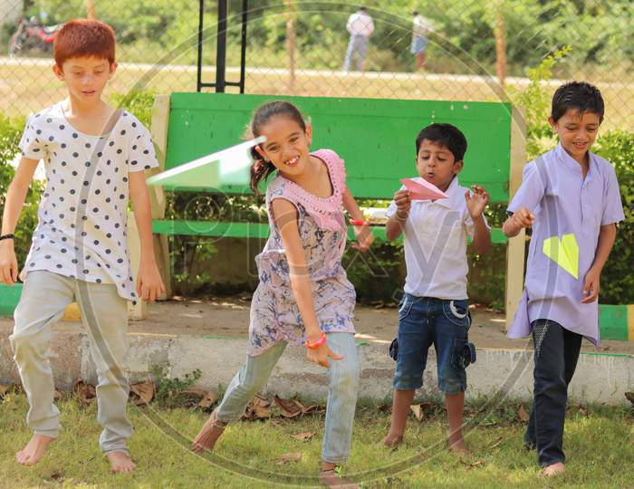 Children's Playing Paper Rocket Game At a Park, Outdoors - Concept Of Kids Enjoying Outdoor Games In Technology-Driven World.