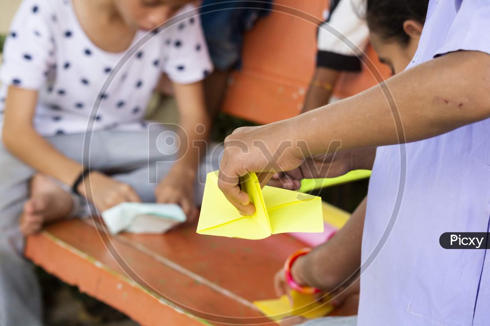 Children's Making Paper Rockets to Play Paper Rockets Game At a Park, Outdoors - Kids Playing Outside During Leisure.