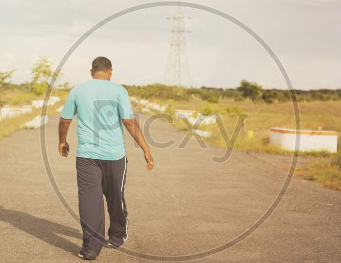 A Young Indian Man Walking or Jogging as a Fitness Routine