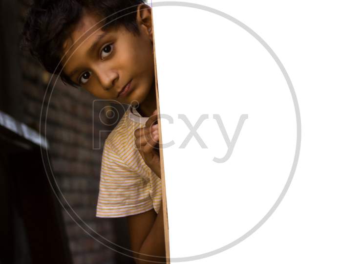 Portrait of a Young Indian Kid through a Wall