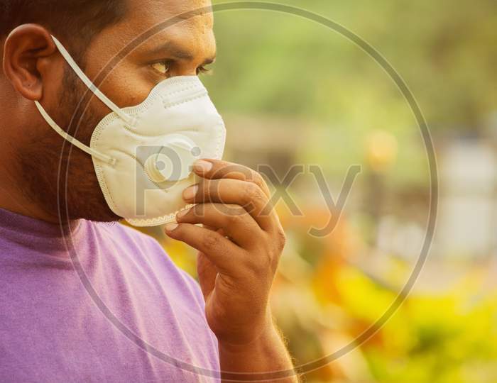 Asian Man Wearing The Face Mask Due To Air Pollution - Young Adult On Park With Pollution Mask - Person Protecting From Air Contamination By Wearing Mask.