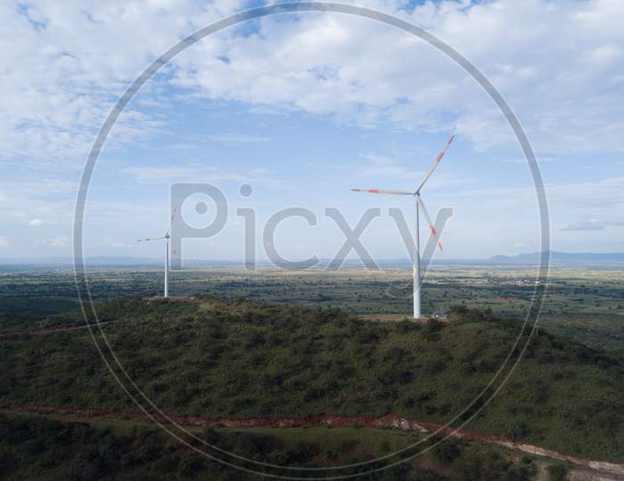 Aerial shot of windmills on a bright sunny day