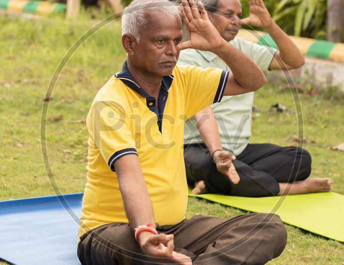 A couple of Elderly Man Or Old Men's Doing Yoga, Fitness Routine At Outdoor